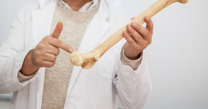 A middle-aged or senior adult standing confidently and actively (e.g., hiking or gardening), with a subtle graphic overlay of a bone structure being scanned (DEXA), symbolizing bone density screening and fracture prevention after 50.